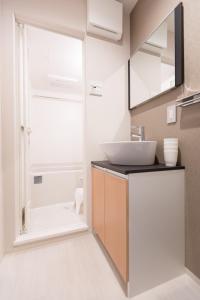 a bathroom with a sink and a shower at Stay SAKURA Kyoto Nijo Seasons in Kyoto