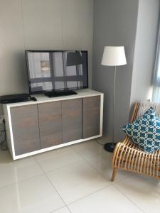 a living room with a tv on a dresser at 101Infinity in Bloubergstrand