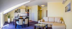 a living room and kitchen with a couch and a table at Apartments Stella Maris in Cavtat