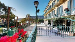 a balcony of a building with a street light and flowers at Hotel Metropole in Santa Margherita Ligure