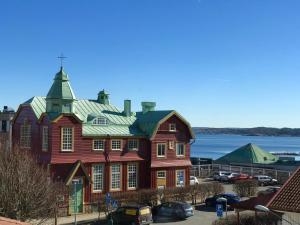 a large wooden house with a green roof at Grand Hotel Lysekil in Lysekil