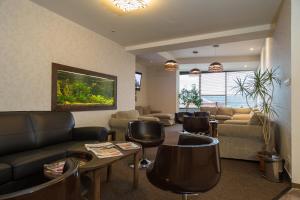 a living room with a couch and chairs at Hotel Polianka in Krpacovo