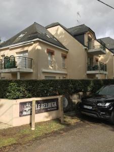 a black car parked in front of a house at Le Belouga in Pornichet