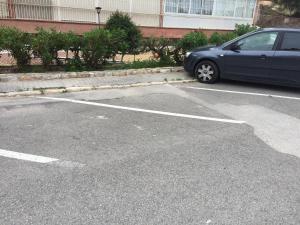 a blue car parked in a parking lot at First line Apartment in Alicante