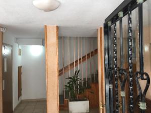 a hallway with a staircase with wine bottles at First line Apartment in Alicante