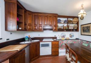 a kitchen with wooden cabinets and a counter top at Cottage san Michele in Rapallo +10 photos