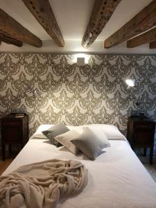 a bedroom with a large white bed with wallpaper at 27@SMarco in Venice