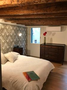 a bedroom with a large bed and a window at 27@SMarco in Venice