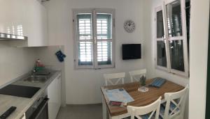 a kitchen with a wooden table and a kitchen with a clock at Karla in Vis