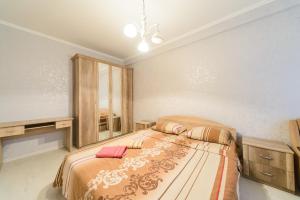a bedroom with a bed and a mirror in it at Квартира по улице Цитадельная, 9 in Kyiv