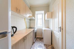 a kitchen with wooden cabinets and a window at Квартира по улице Цитадельная, 9 in Kyiv