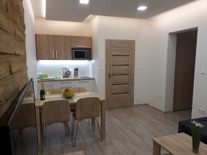 a kitchen and dining room with a table and chairs at Apartment Jasna - Lucky in Demanovska Dolina