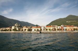 a group of buildings on the shore of a body of water at B&B 21 in Cannobio
