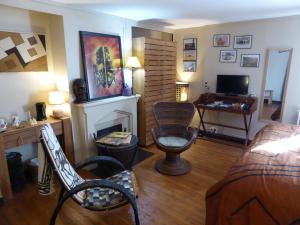 a living room with a bed and a fireplace at B&B A La Maison Blanche in Fécamp