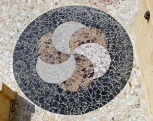 a letter s on a mosaic tile floor at The Pyramid Lofts in Cairo