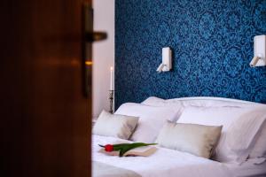 a bedroom with a white bed with a blue wall at Apartments Marmont in Split