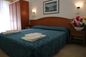 Voodi või voodid majutusasutuse Hotel Orchidea toas
