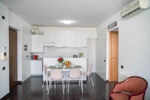 a kitchen with a table and chairs in a room at Darsena Apartment in Genova