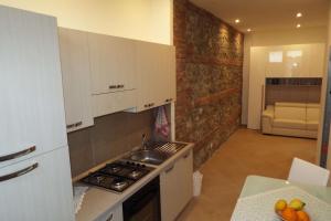 a kitchen with a sink and a stove top oven at Cefalù Studio Room and Apartments in Cefalù