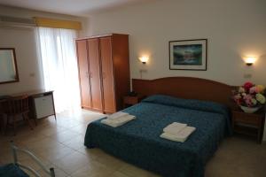 Voodi või voodid majutusasutuse Hotel Orchidea toas