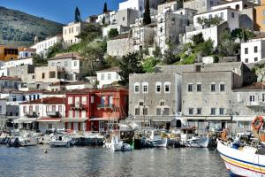 a group of boats docked in a harbor with buildings at Douskos Port House in Hydra