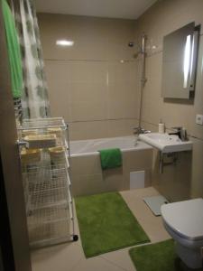 a bathroom with a tub and a sink and a toilet at Chambres Mountain in Poiana Brasov +20 photos