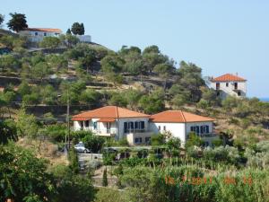 a group of houses on a hill at Ktima Pyroessa Blue Suite in Thános