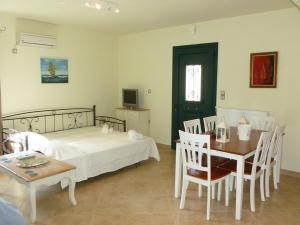 a bedroom with a bed and a table and chairs at Ktima Pyroessa Blue Suite in Thános