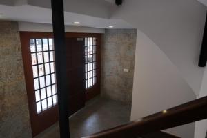 a hallway with doors and windows in a building at Apartamentos Guillem in Playa de Miramar