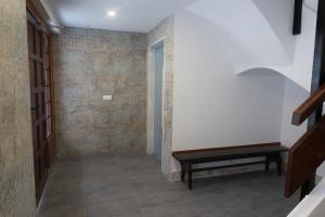 a hallway with a bench next to a door at Apartamentos Guillem in Playa de Miramar