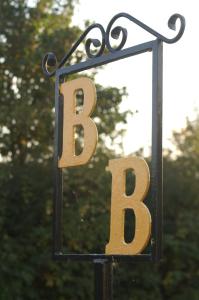 a metal sign with the letter b on a pole at Y-NOT Guest House in Boston