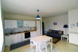a kitchen and living room with a table and a couch at CYTRUS apartament in Marina di Massa