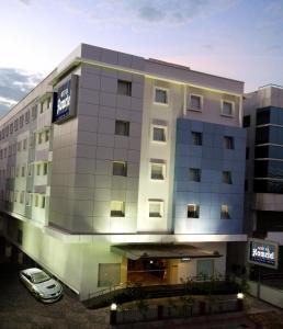 a hotel with a car parked in front of it at Aditya Hometel in Hyderabad