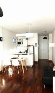 a kitchen and living room with a table and chairs at M & C Suites in Buenos Aires