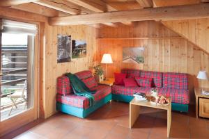 a living room with a couch and a table at Albergo Diffuso Sauris in Sauris Di Sopra in Sauris