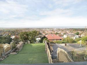 a view from the balcony of a house with a green yard at Hillside Cottage in Prestatyn