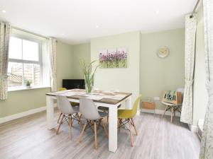 a dining room with a table and chairs at Hillside Cottage in Prestatyn