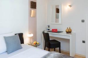 a bedroom with a bed and a desk with a laptop at Hotel Villa Rosa in Allershausen