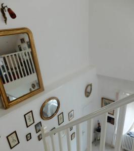 a stairway with a mirror and a stair case at Villa Vero in Contrexéville