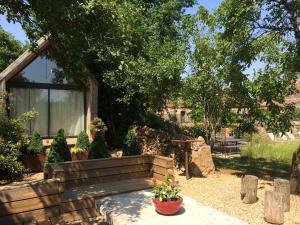 a garden with a house and some plants at La Maison Du Meunier in Loze