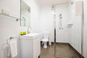 
a bathroom with a shower, toilet and sink at Nightcap at Finsbury Hotel in Adelaide
