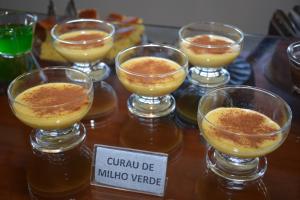 a group of wine glasses sitting on a table at Hotel Cosini in São Sebastião do Paraíso