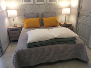a bedroom with a bed with two lamps on both sides at Sainte Maxime 4 pièces in Sainte-Maxime +26 photos