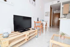 Televízia a/alebo spoločenská miestnosť v ubytovaní P&P Apartaments Carrera de Capuchinos