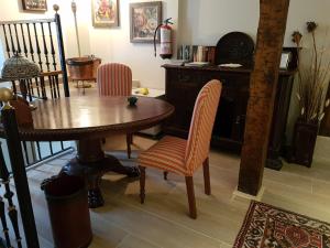 a dining room with a wooden table and chairs at Hostal El Resbalon in Cervera de Pisuerga