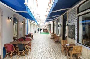 an alley with tables and chairs in a street at The Surf Studio - Ericeira in Ericeira
