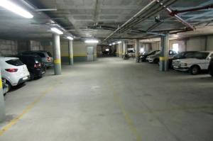 a parking lot with cars parked in a parking garage at The Surf Studio - Ericeira in Ericeira