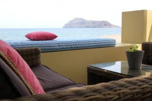 a room with a bed and a view of the ocean at Effi Apartments in Plataniás