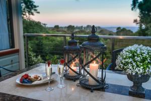 a table with two candles and a plate of food at Mountain Whispers Chatelaine Valley in Katoomba