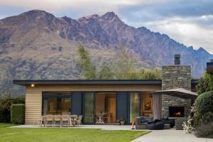 a house with mountains in the background at Alpine Retreat in Queenstown